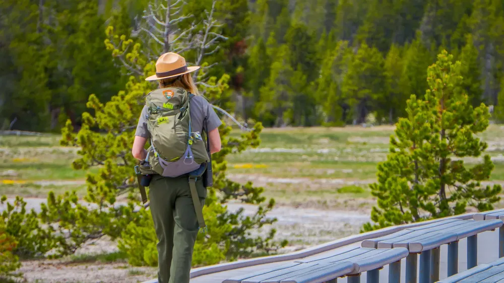 female national park ranger walking in park
